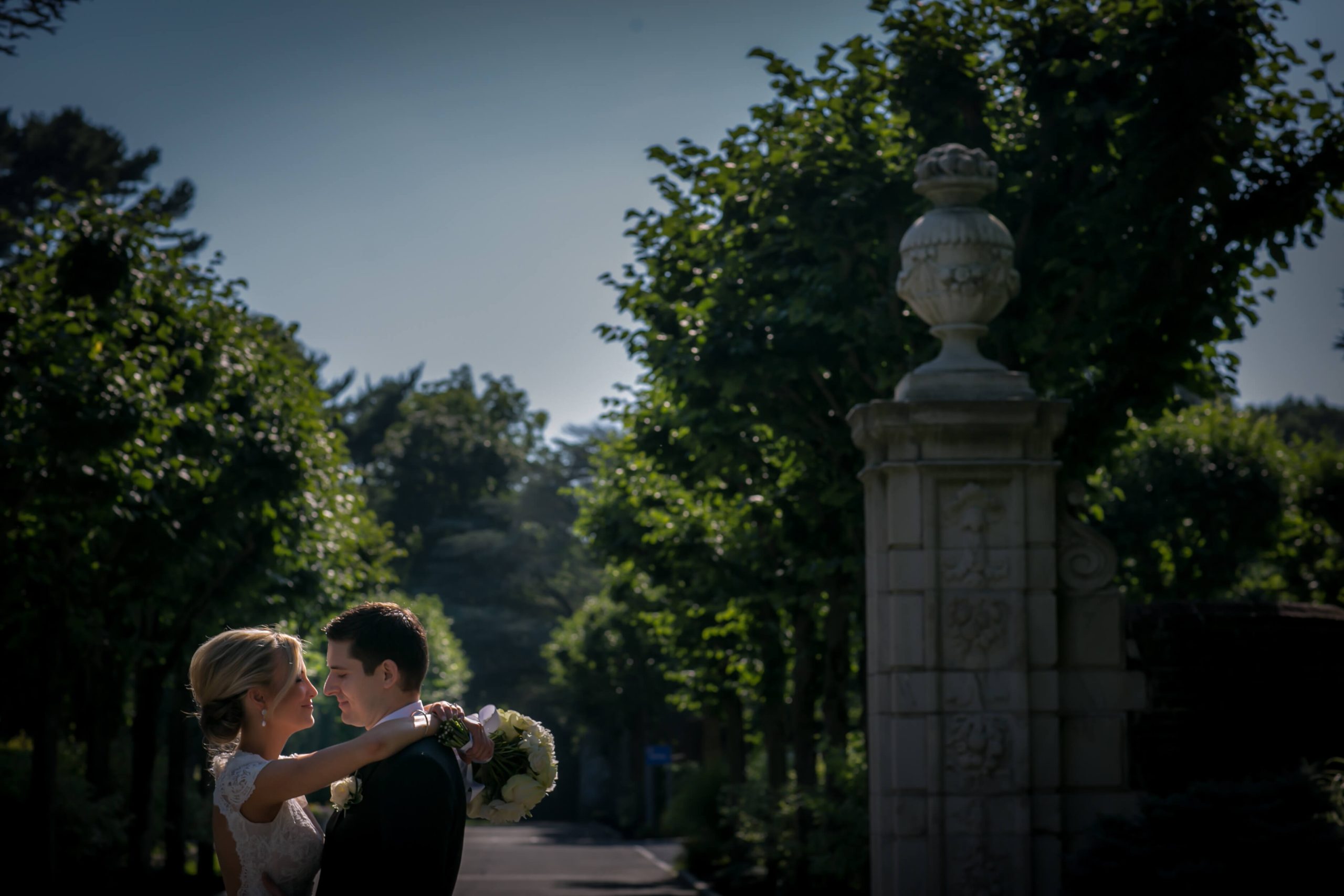 bride and groom embracing in gardens