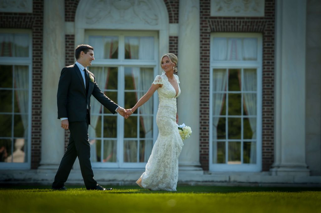 bride and groom walking at elegant mansion