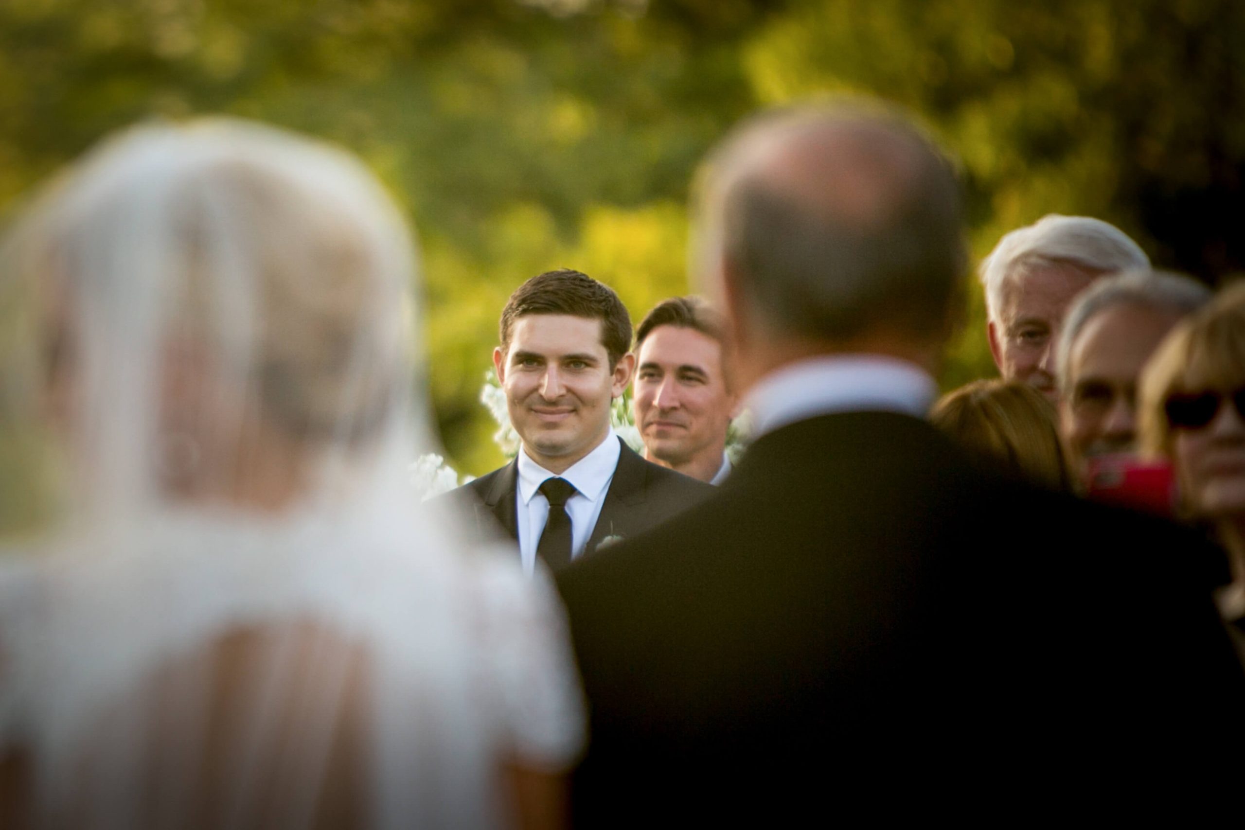 groom reacts to bride at wedding ceremony