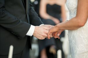 bride and groom holding hands at ceremony