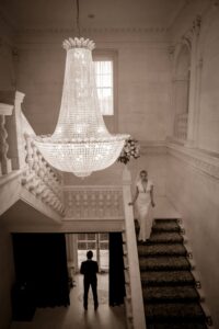 first look of bride walking down staircase