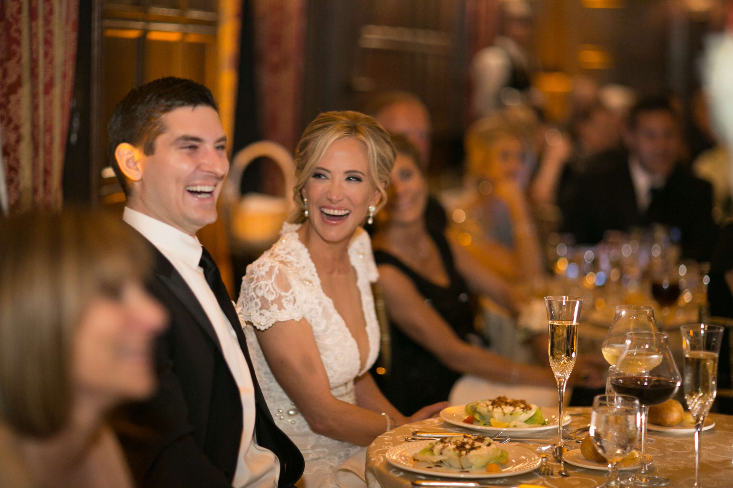 bride and groom laughing during speech