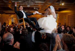 exciting jewish horrah wedding tradition with bride and groom