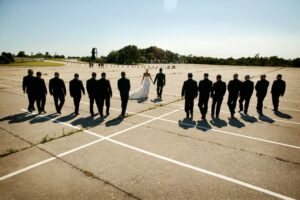 wedding party walking in abandoned parking lot