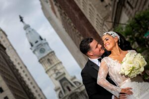 bride and groom with tall building in background