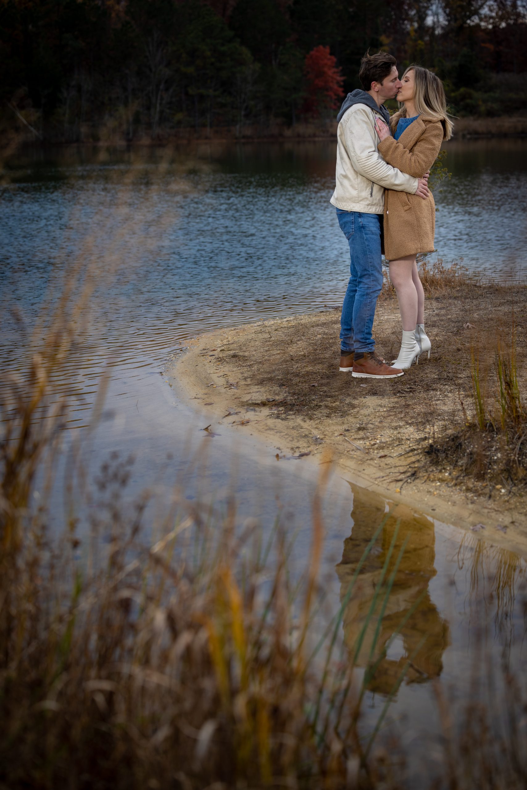 engagement photo kissing by lake