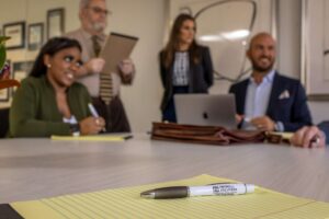 lawyers talking with pen and notepad on desk
