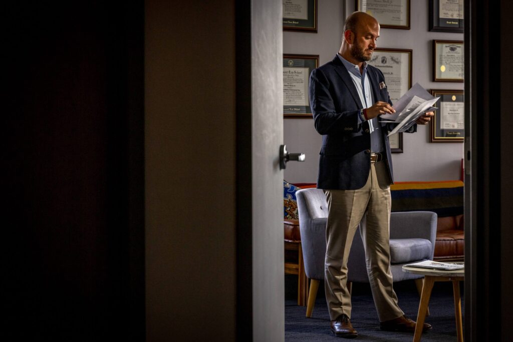 man in suit reading a letter