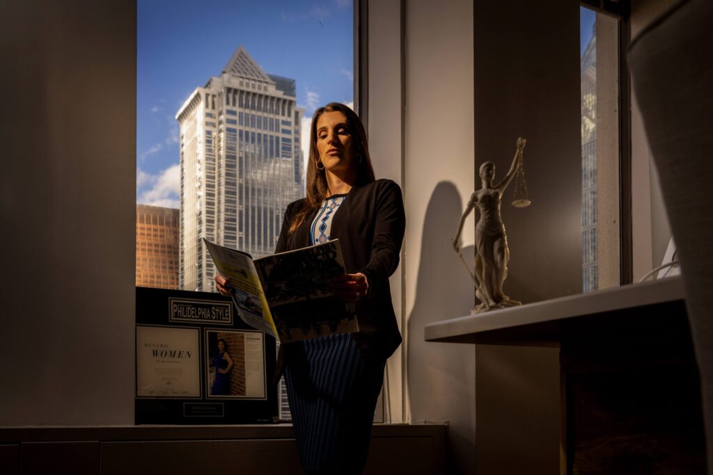 woman reading book in office