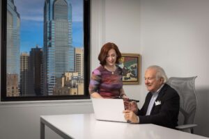 man and woman working at computer
