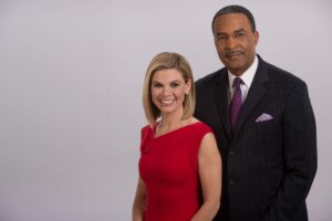 man in purple tie and woman in red dress