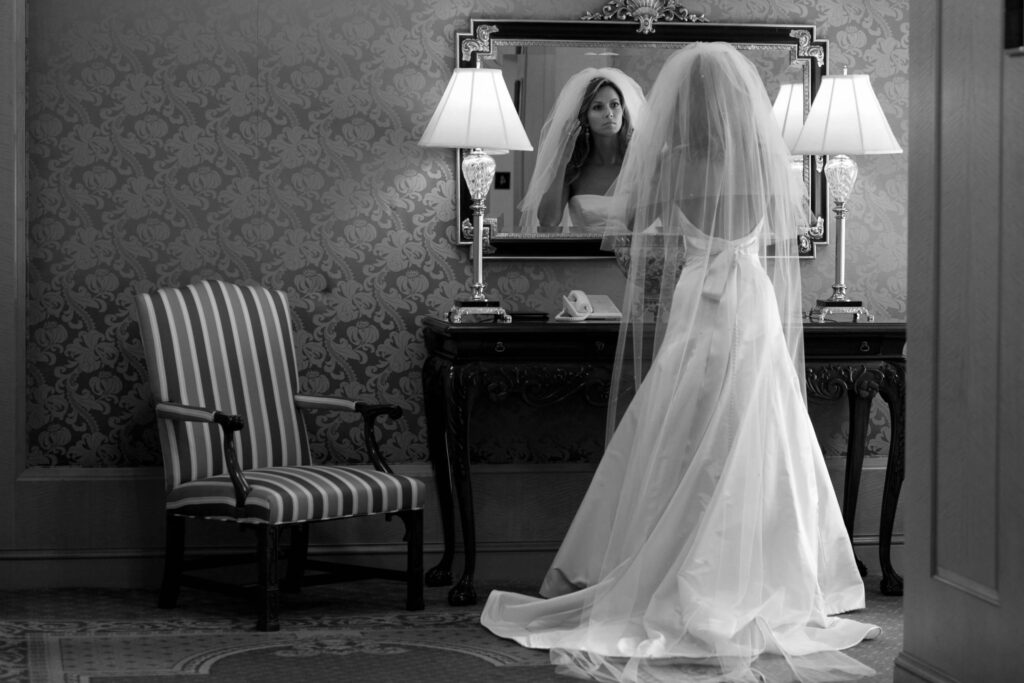 bride looking in elegant mirror
