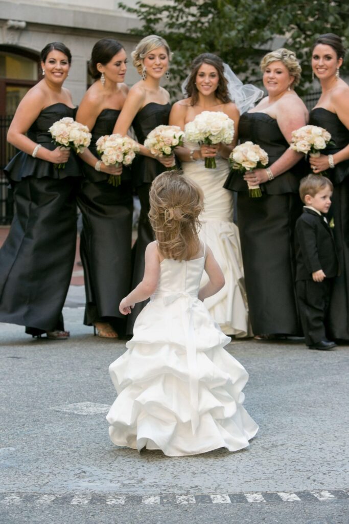 flower girl looks at bridesmaids and bride