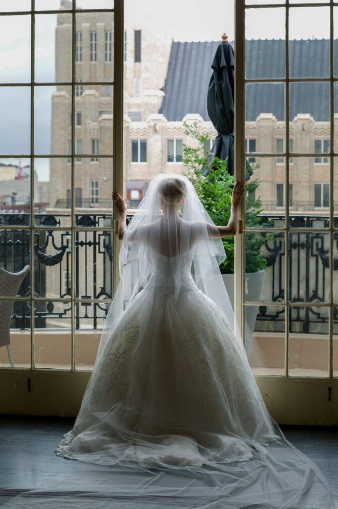 bride looking over a balcony in city