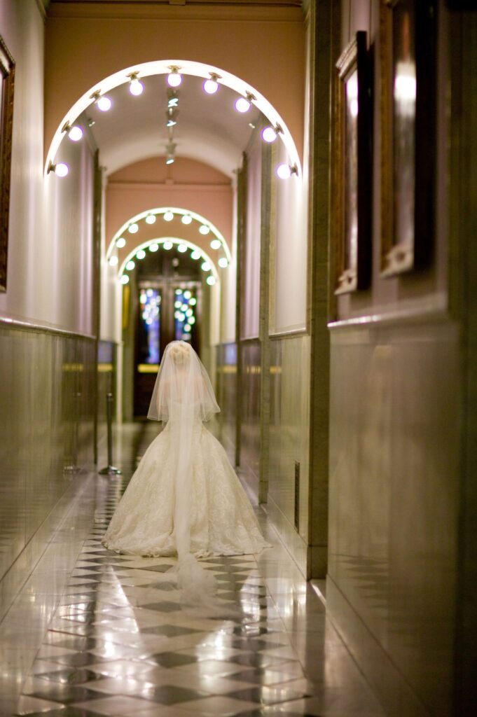 bride walking through hallway at wedding