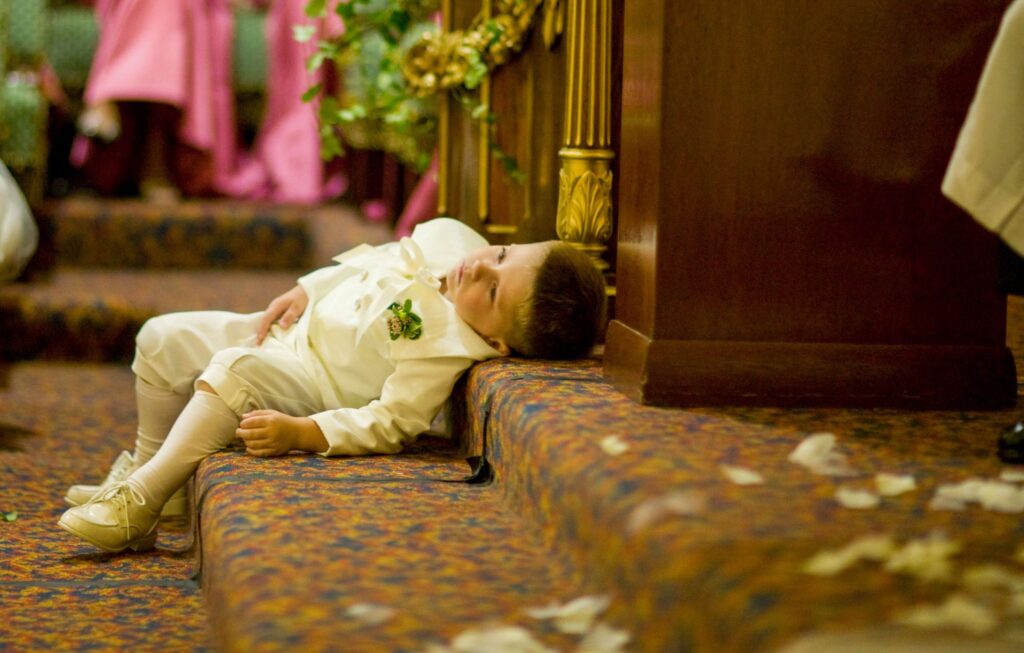 young boy in suit leaning on stairs