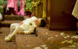 young boy in suit leaning on stairs