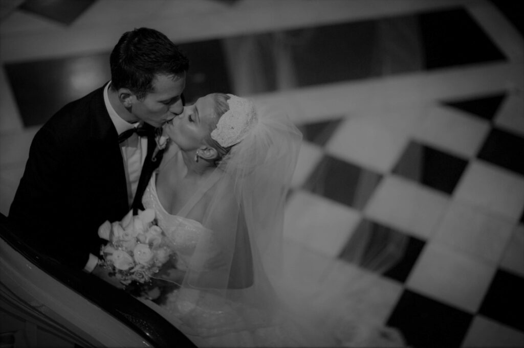 bride and groom kissing on stairs