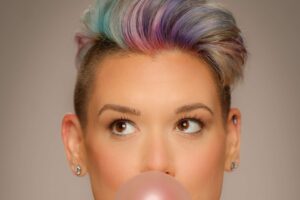 woman blowing a bubble with gum