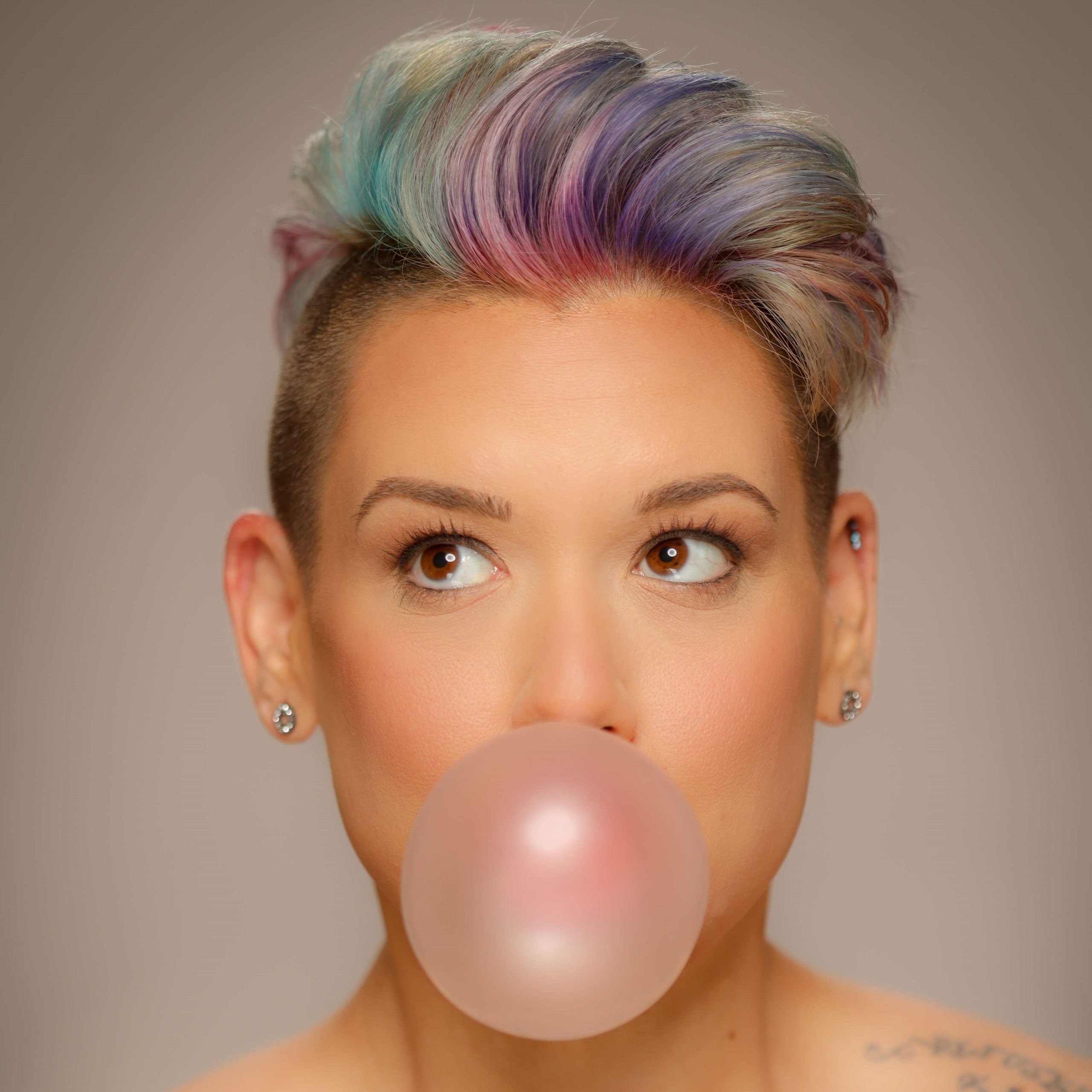 woman blowing a bubble with gum