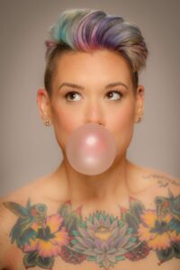 woman blowing a bubble with gum