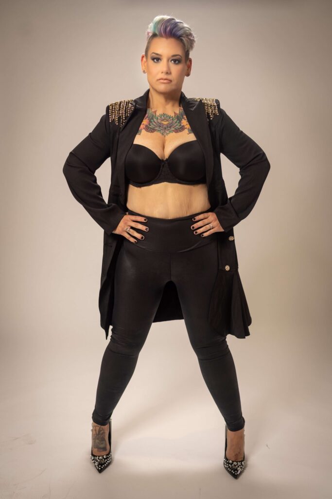 tattooed woman in a power stance