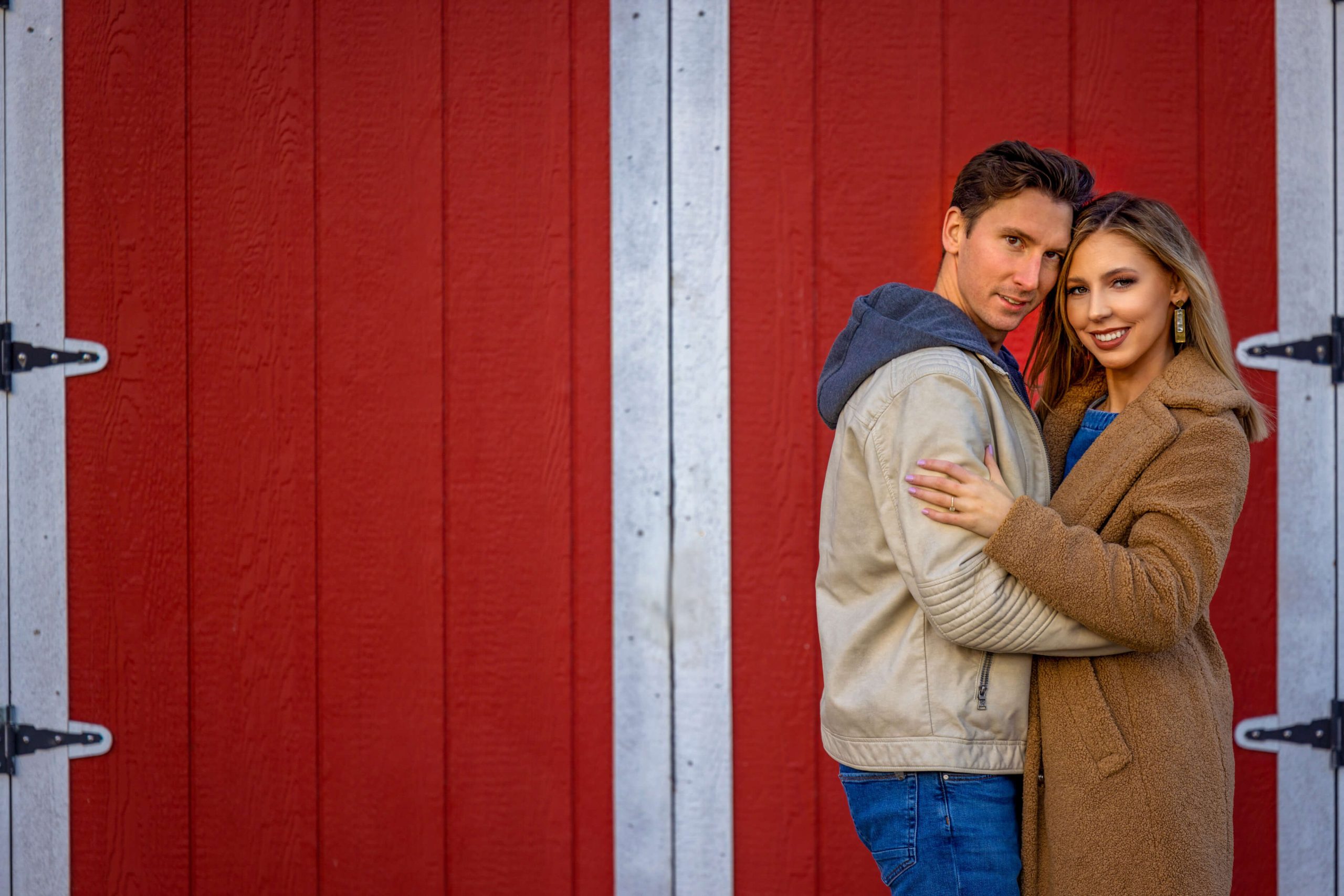 engagement photo against a red shed