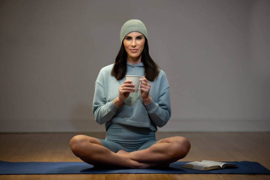 woman on yoga mat in blue outfit