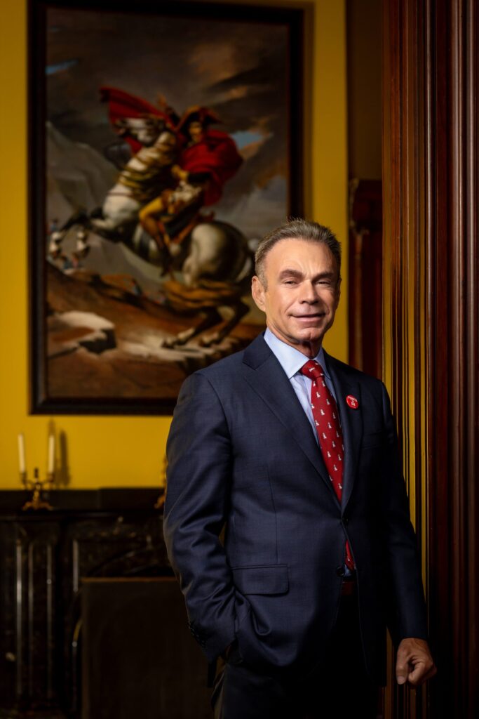 man in suit with napoleon painting