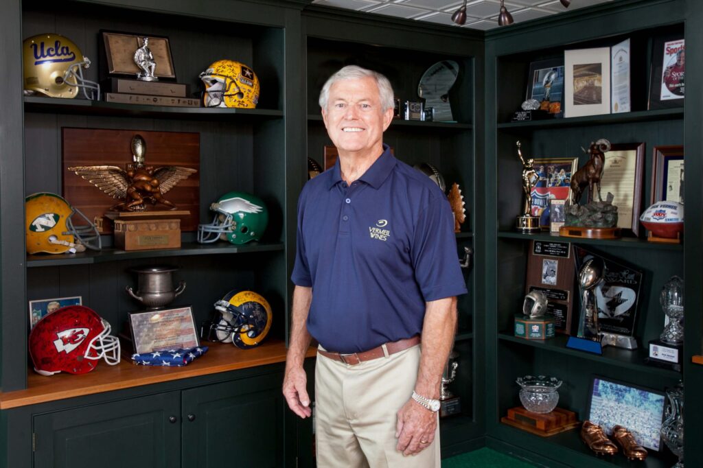 dick vermeil posing in trophy room