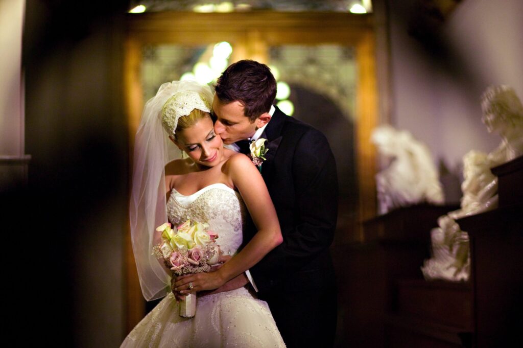 groom kissing bride on cheek
