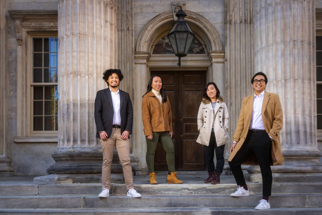four stylish friends at column building