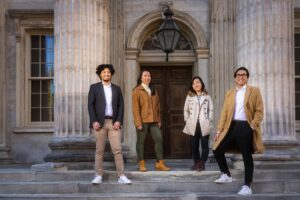 four stylish friends at column building