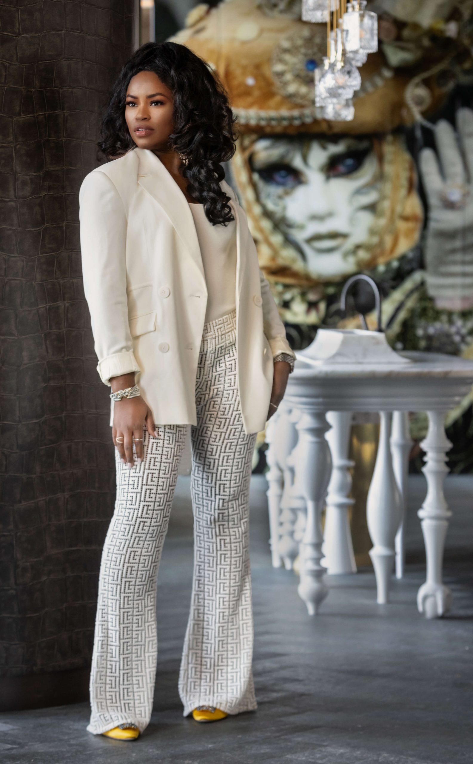 blonde woman in red dress in an all-turquoise room 