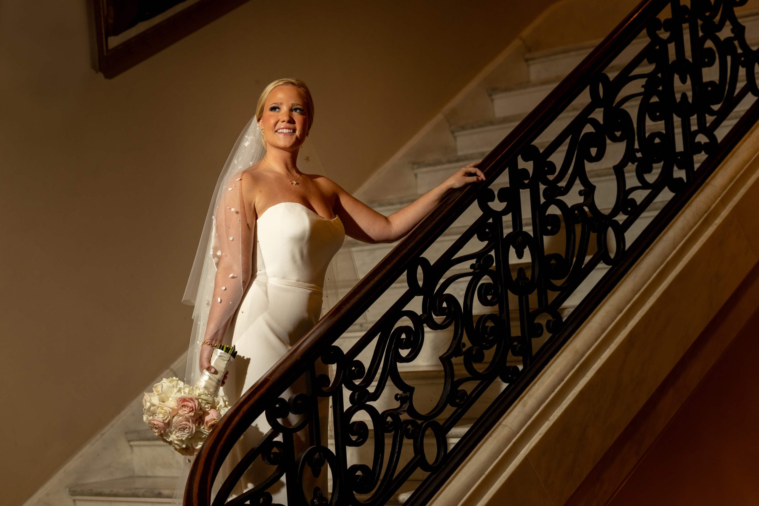 bride in wedding dress at stairs