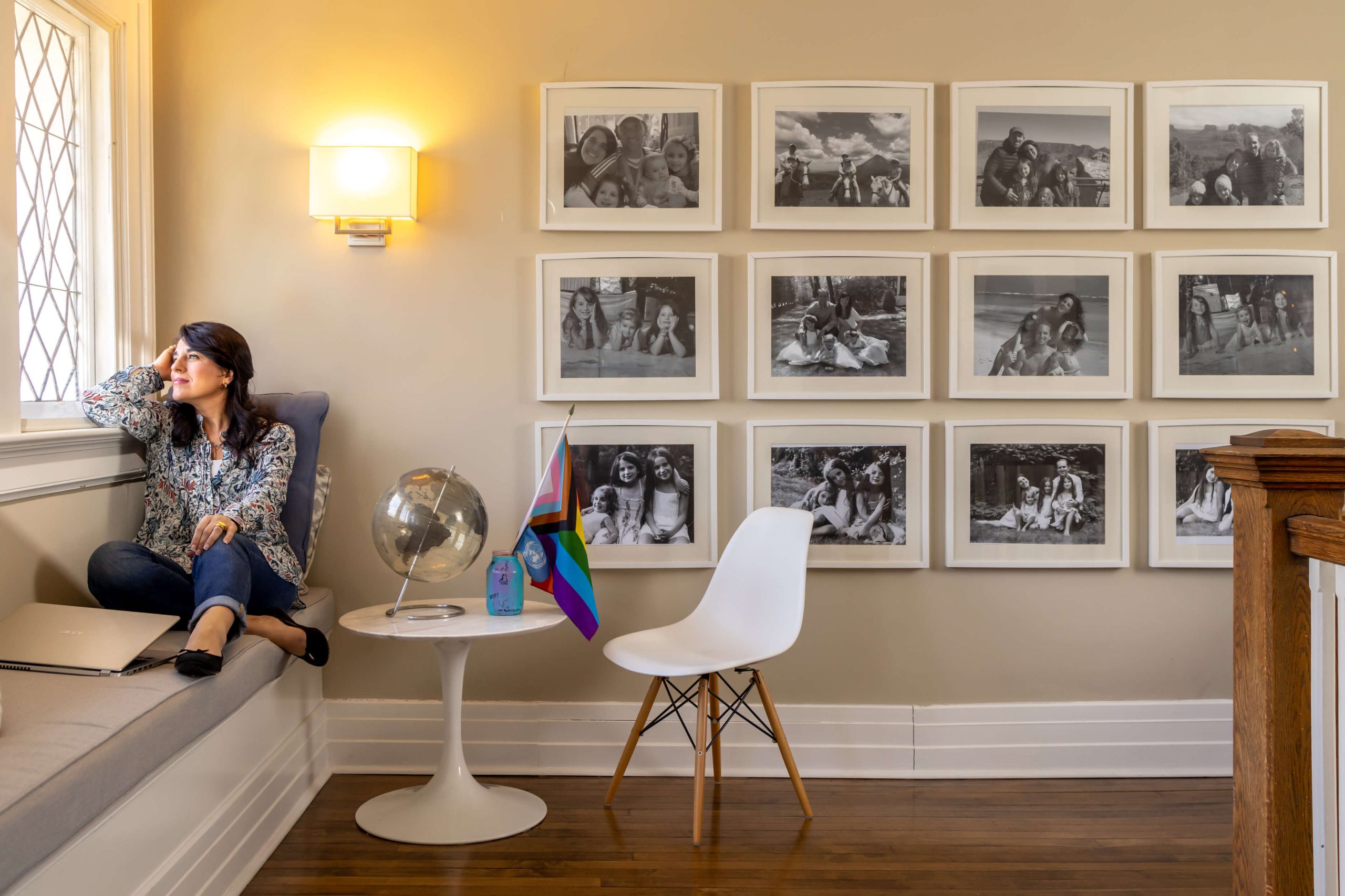 woman gazing out of a window in a living room setting