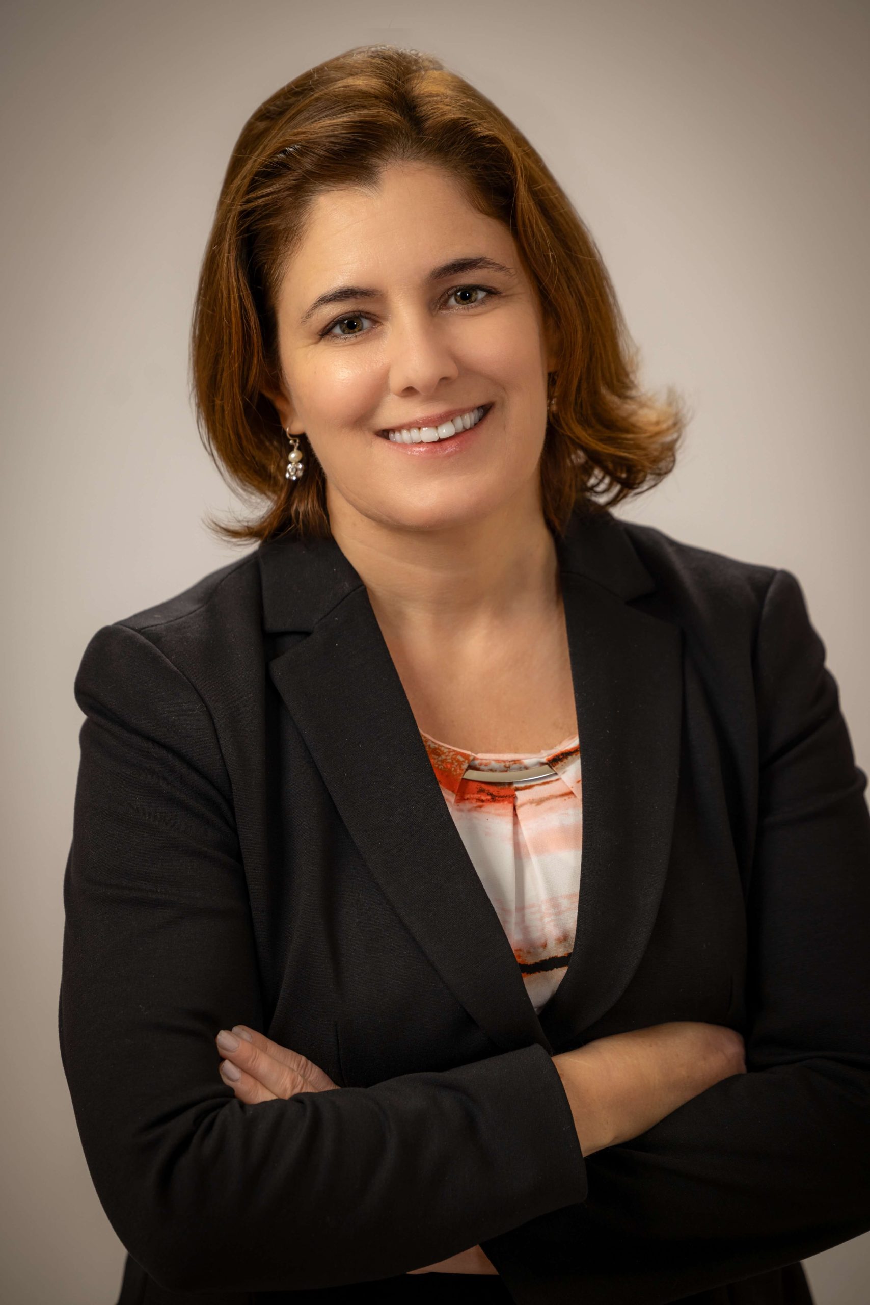 woman wearing black suit and crossing arms