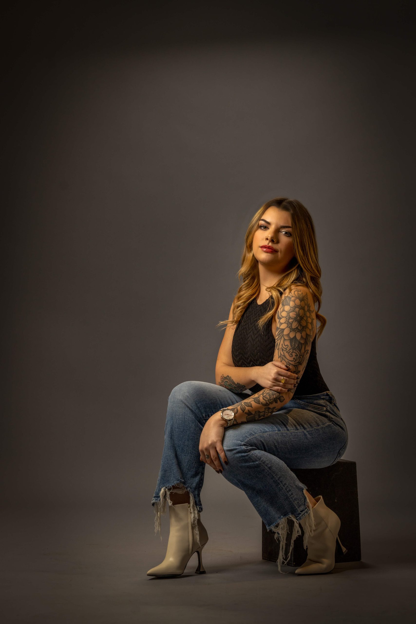man with hair bun and blue collared shirt