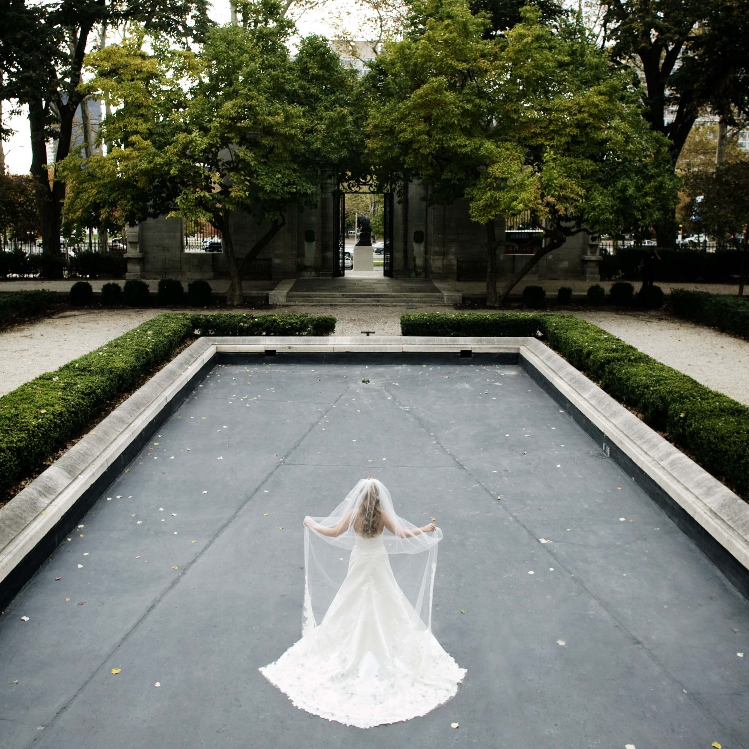 bride in empty water fountain