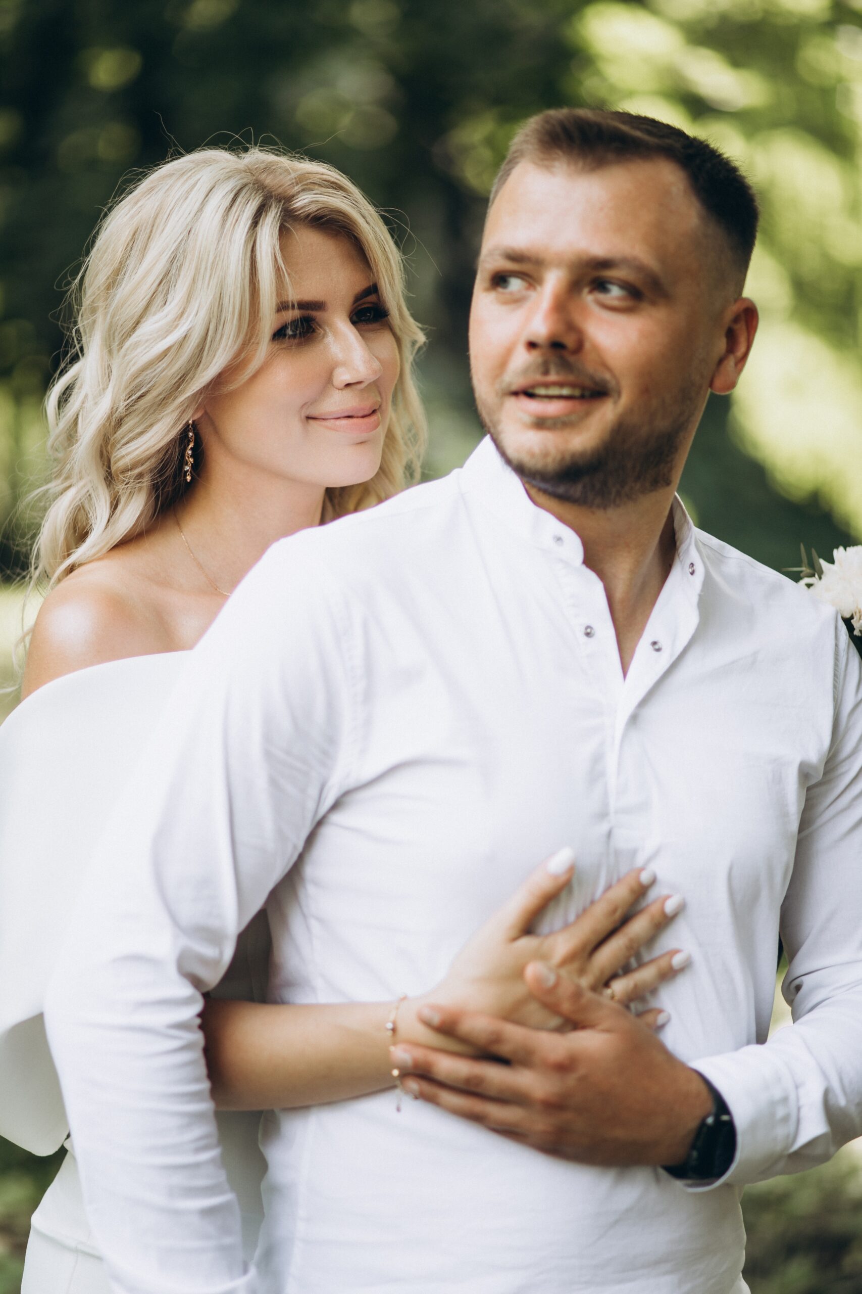 woman smiling and holding man by face