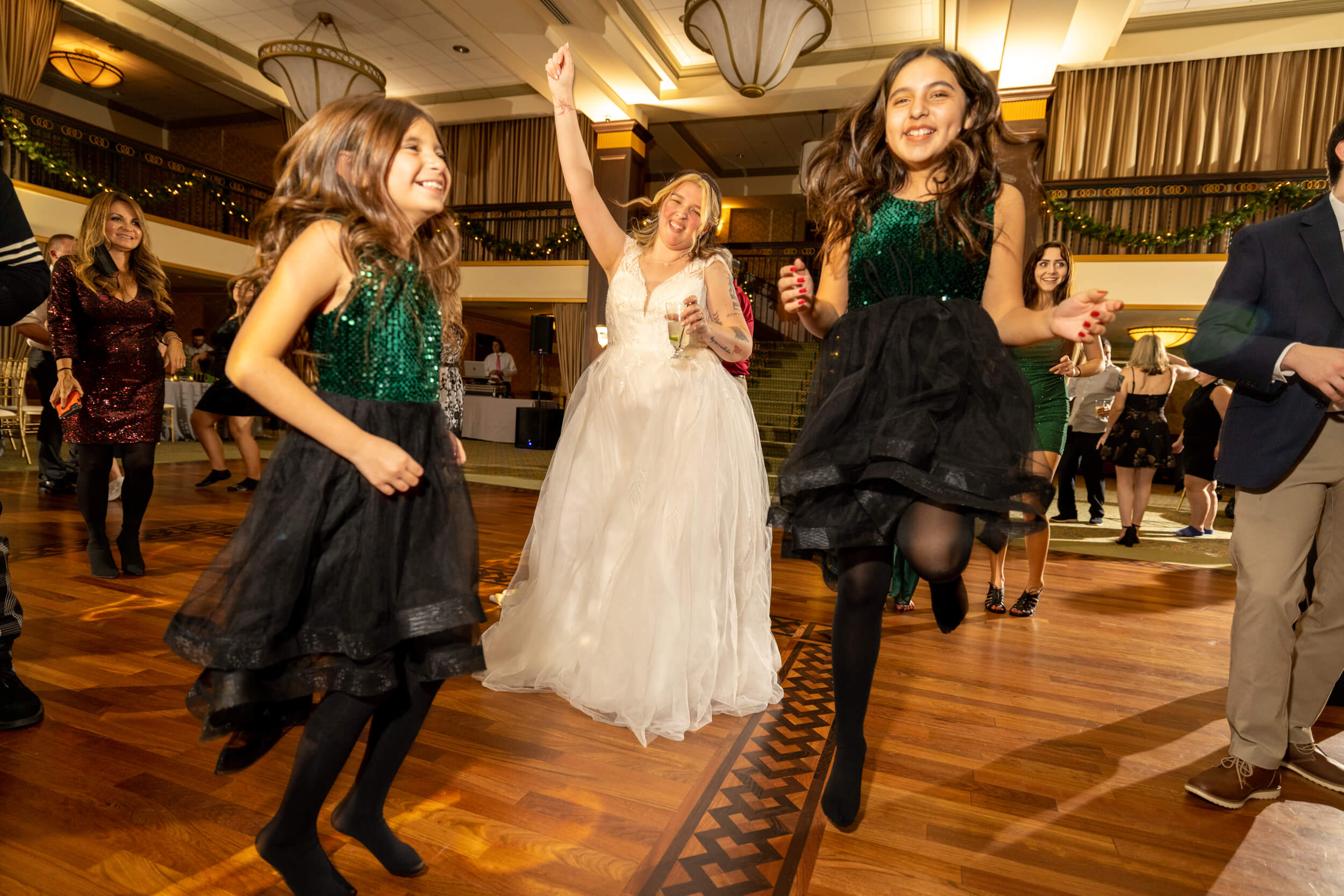 bride and two girls dancing in ballroom