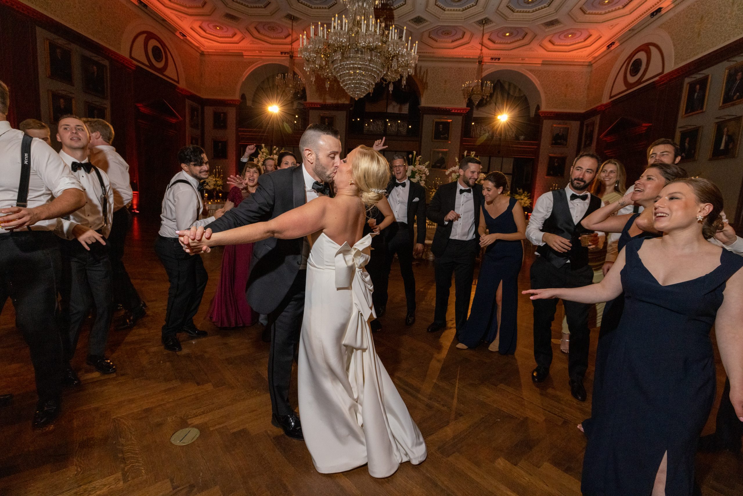 bride and groom kissing on dance floor