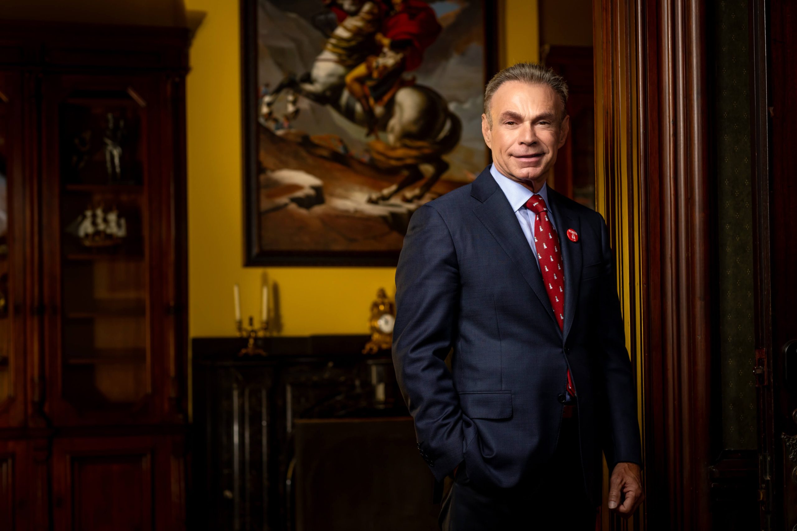 man in teal striped suit against brown wall