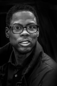 man wearing black frame glasses and coat