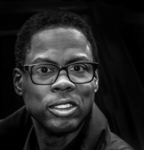 man wearing black frame glasses and coat