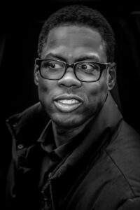 man wearing glasses and coat