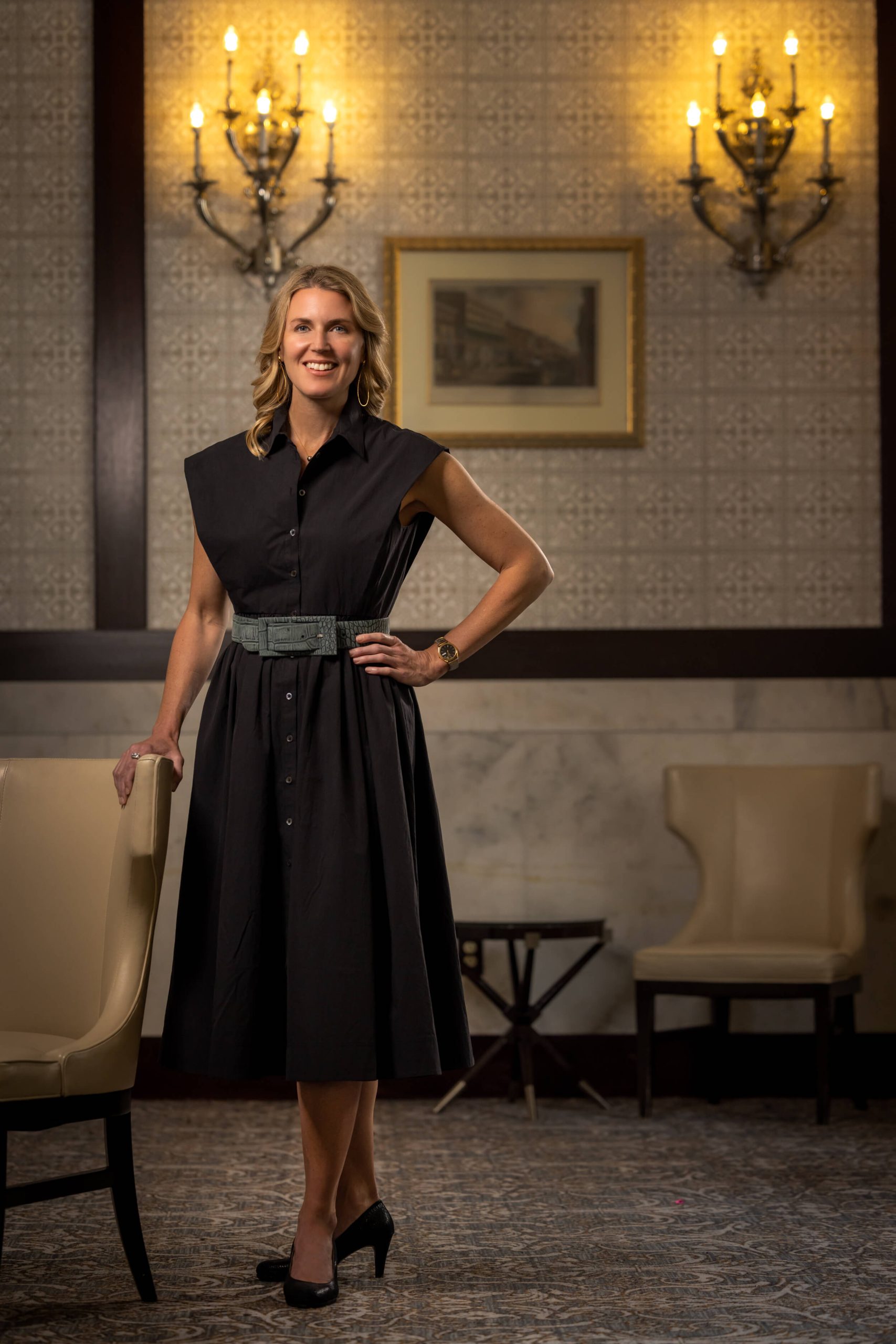 bride posing in an elegant hallway with flowers
