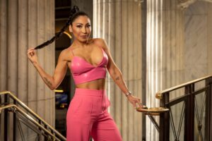 woman in hot pink clothes holding braided ponytail