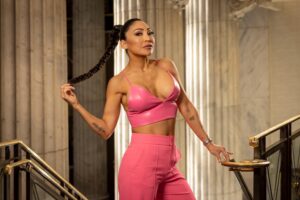 woman in hot pink top and pants at staircase