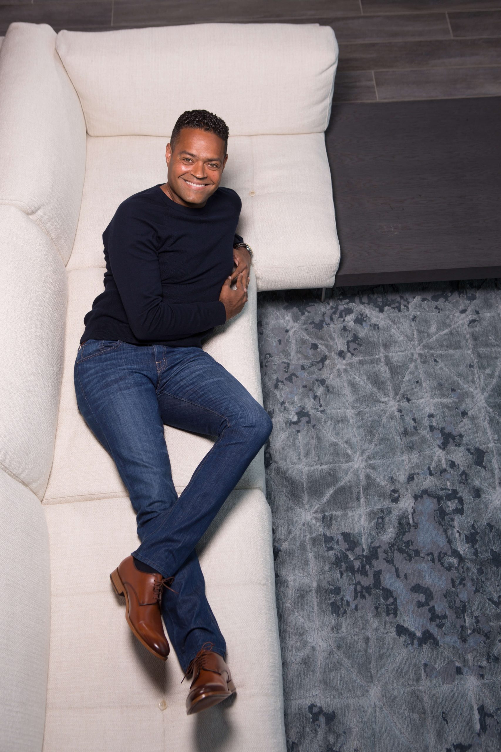 man in blue suit against blue glass circles